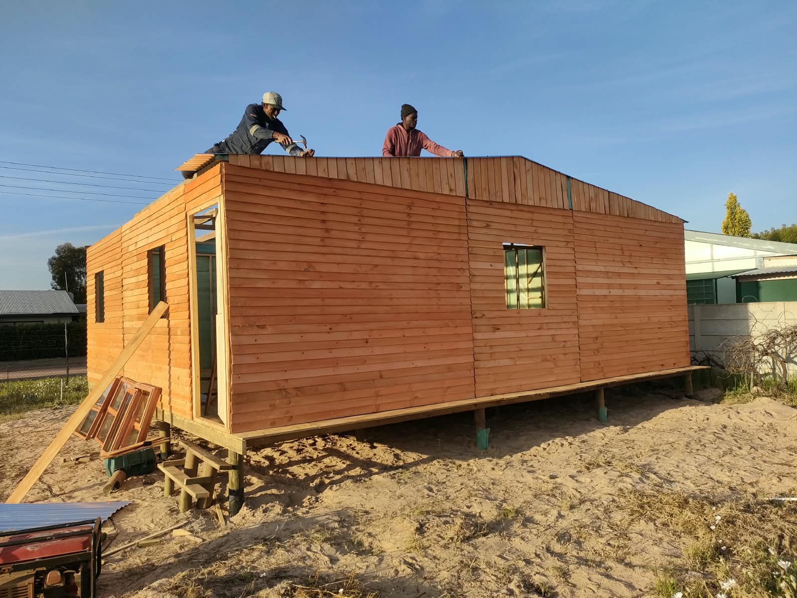 Our team building a large timber Wendy house on a raised wooden base