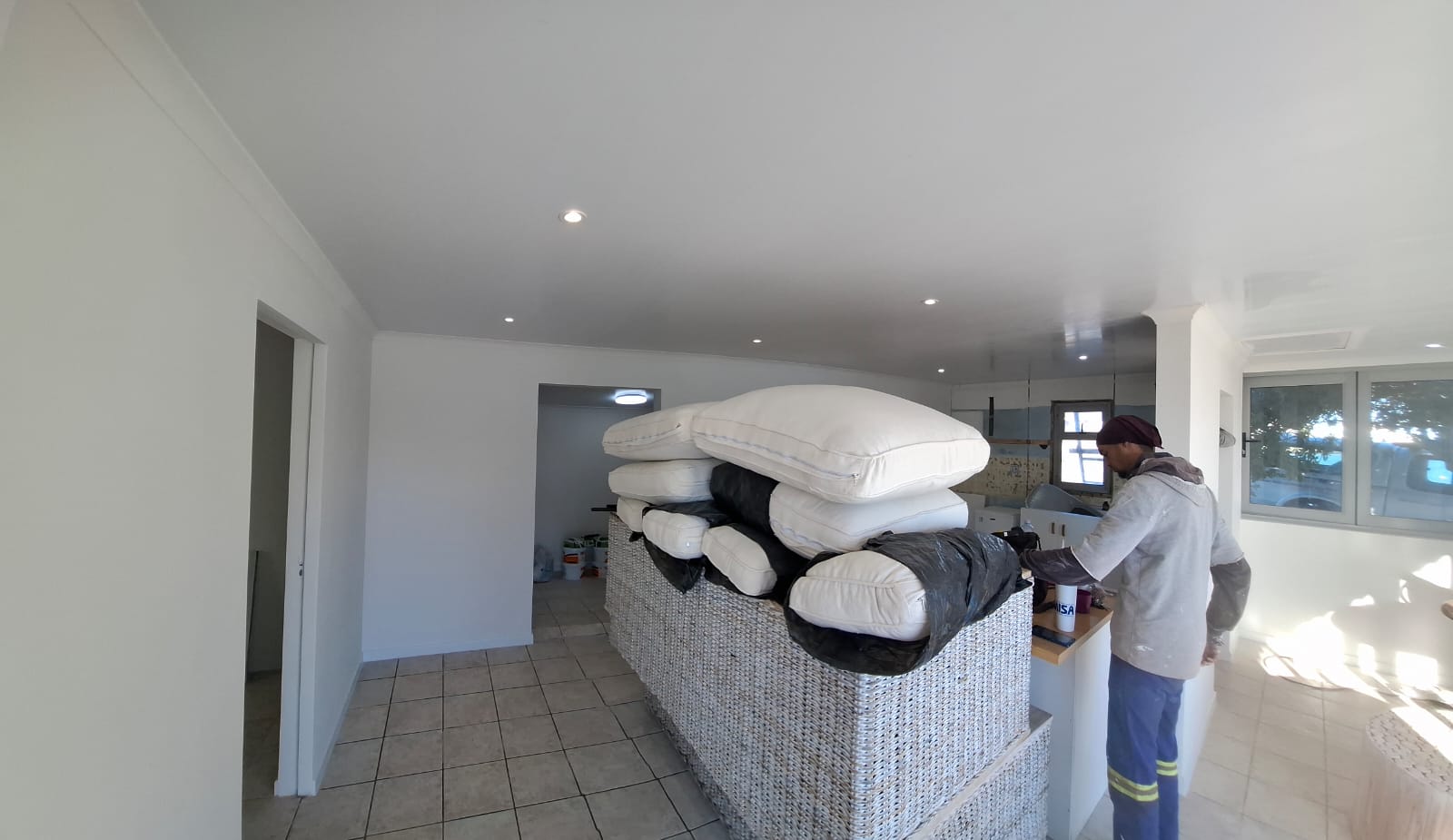 An open-plan interior fit-out with tiled floors and downlights